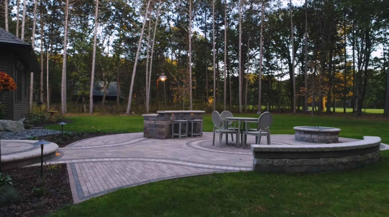 Custom hardscaping with patio pavers and fire pit area